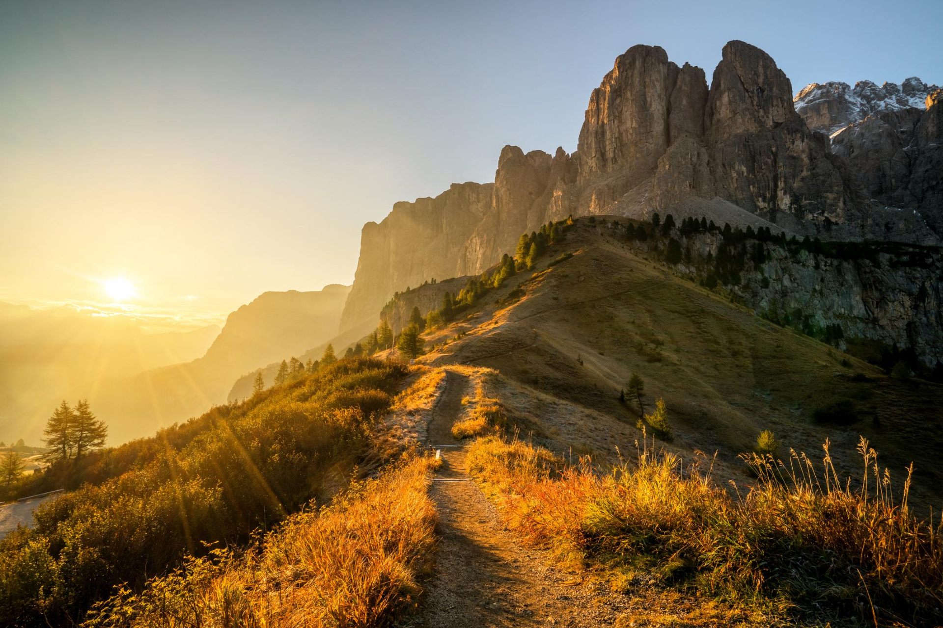 Empty ridgeline trail at golden sunrise in the Dolomites